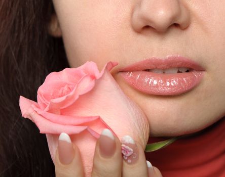 The woman with a rose. A photo close up parts of the person and a flower