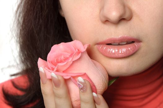 The woman with a rose closeup. Isolated on white