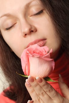 The woman with a rose. A photo close up parts of the person and a flower