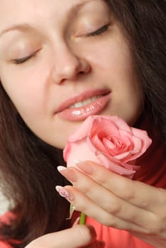 The woman with a rose. A photo close up parts of the person and a flower