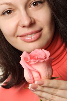 The woman with a rose. A photo close up parts of the person and a flower