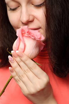 The woman with a rose. A photo close up parts of the person and a flower