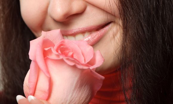 The woman with a rose. A photo close up parts of the person and a flower