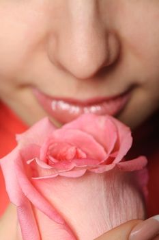 The woman with a rose. A photo close up parts of the person and a flower