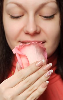 The woman with a rose. A photo close up parts of the person and a flower