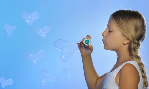 The pretty girl with bubbles heart. A  blue background