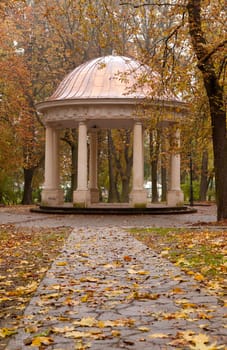 Autumn park with a footpath to summer house. The Lvov park