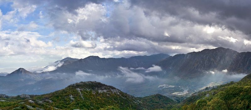 panoramic view of autumn in mountains with dramatic sky