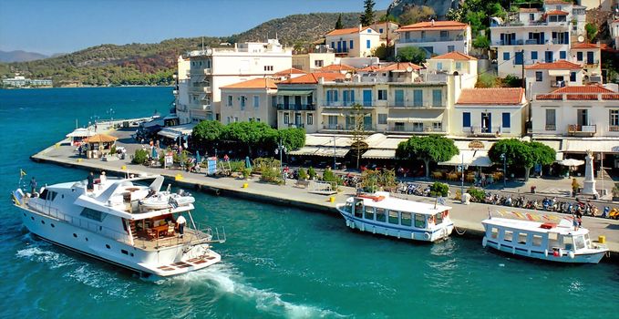 Yacht is doubling town quay in Greek island