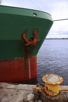 steel cargo ship docked in the bay