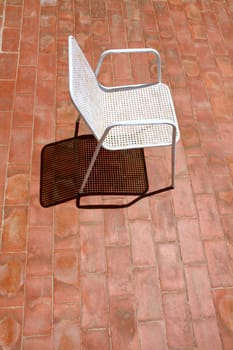 a chair waiting for a relaxing sunbath, alone on the terrace