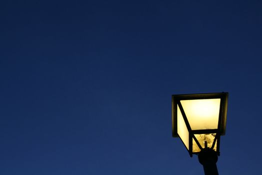 yellow light of a street lamp and a dark blue background