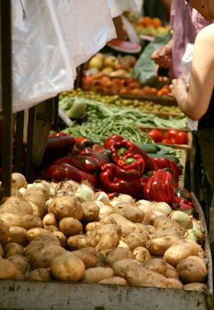 street market vegetables and fruits a person buying