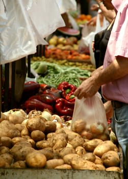 street market vegetables and fruits a person buying