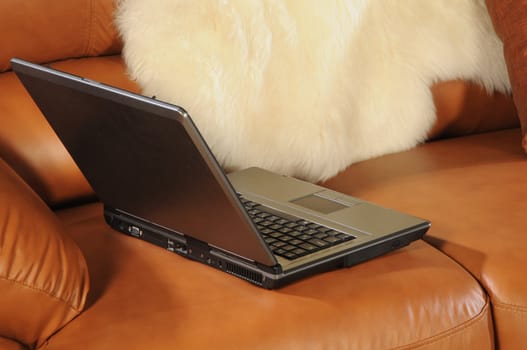 Close up laptop on brown leather sofa