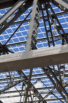 Detail of steel structure of a roof against a blue sky