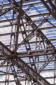 Detail of steel framework of a roof against a blue sky