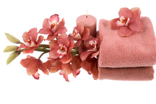A beautiful orchid, towel and candle
