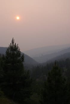 Sun setting behind forest fire smoke in the California Sierra's