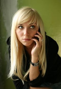 The nice blonde with the phone on a green background