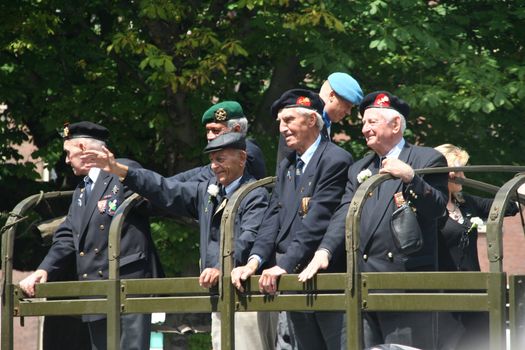 Veteran soldiers on a truck in a veterans day parade