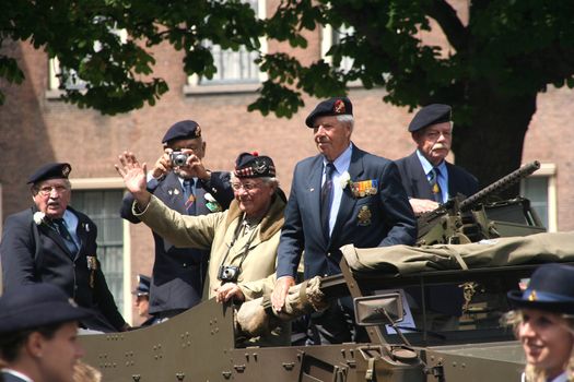 Veterans on an armoured vehicle on Veterans Day parade