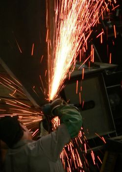 A man grinding steel.