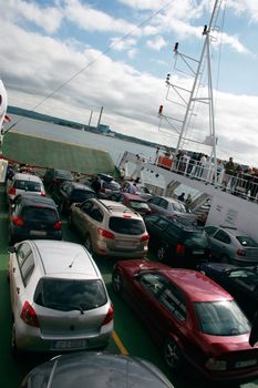 people and cars on the deck of a car ferry