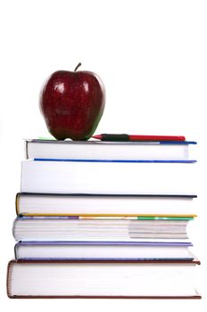 School books, pencil and red apple