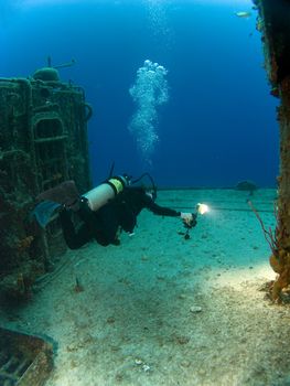 Female Underwater Photographer with Strobe Firing