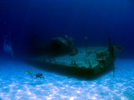 Videographer filming the sunken Shipwreck Tibbits in Cayman Brac