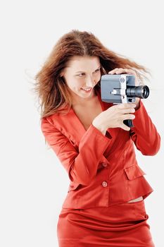Young woman in red suit to hold old video camera