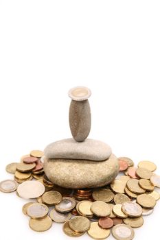 Coins and Pepples on white background as a symbol for financial balance