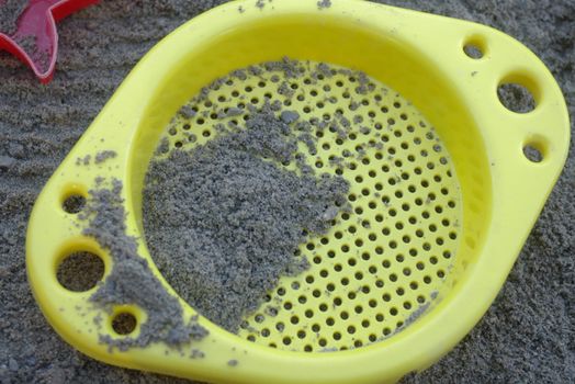 colorful plastic toys in a sandbox