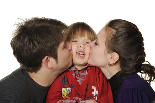 Mum and the daddy kiss the son. It is isolated on a white background