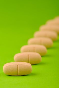 set  red tablets on green background. Photo closeup