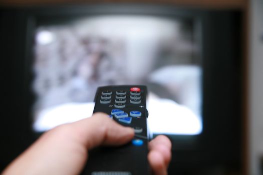 a remote control pointing to a tv.