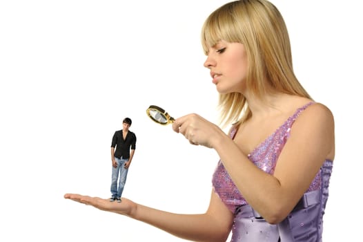 The girl considering the guy through a magnifier. The potential groom.It is isolated on a white background