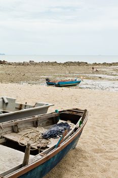 Fishing Boats on the beach near the ocean in view.
