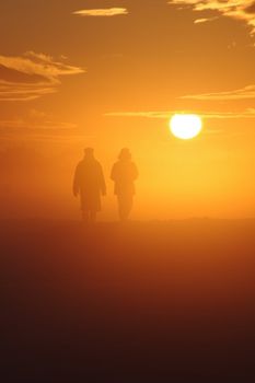 a couple have a walk through a misty landscape