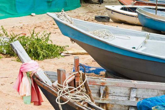 Fishing Boats on the beach near the ocean in view.