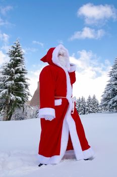 Santa Claus, Father Christmas in a beautiful winter landscape