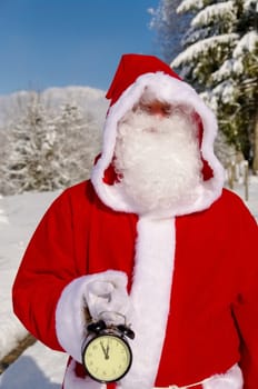 Santa Claus, Father Christmas holds watch clock