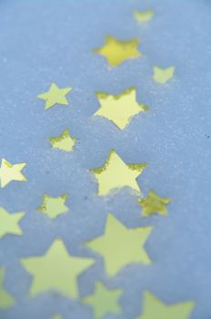 golden snow stars on a real snowy icy surface