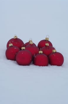 a red bauble in snowy lwinter andscape