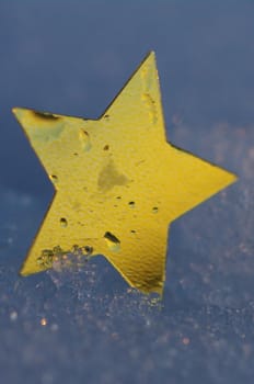 golden snow stars on a real snowy icy surface