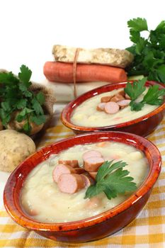 a red bowl of potato soup with parsley