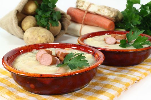 a red bowl of potato soup with parsley
