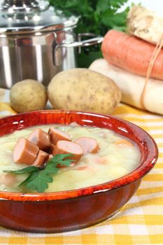 a red bowl of potato soup with parsley