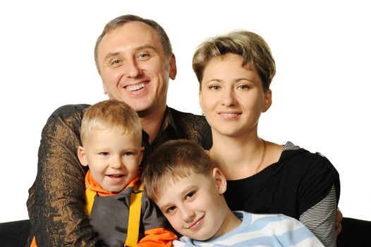 Happy family. The daddy, mum, two sons. It is isolated on a white background.